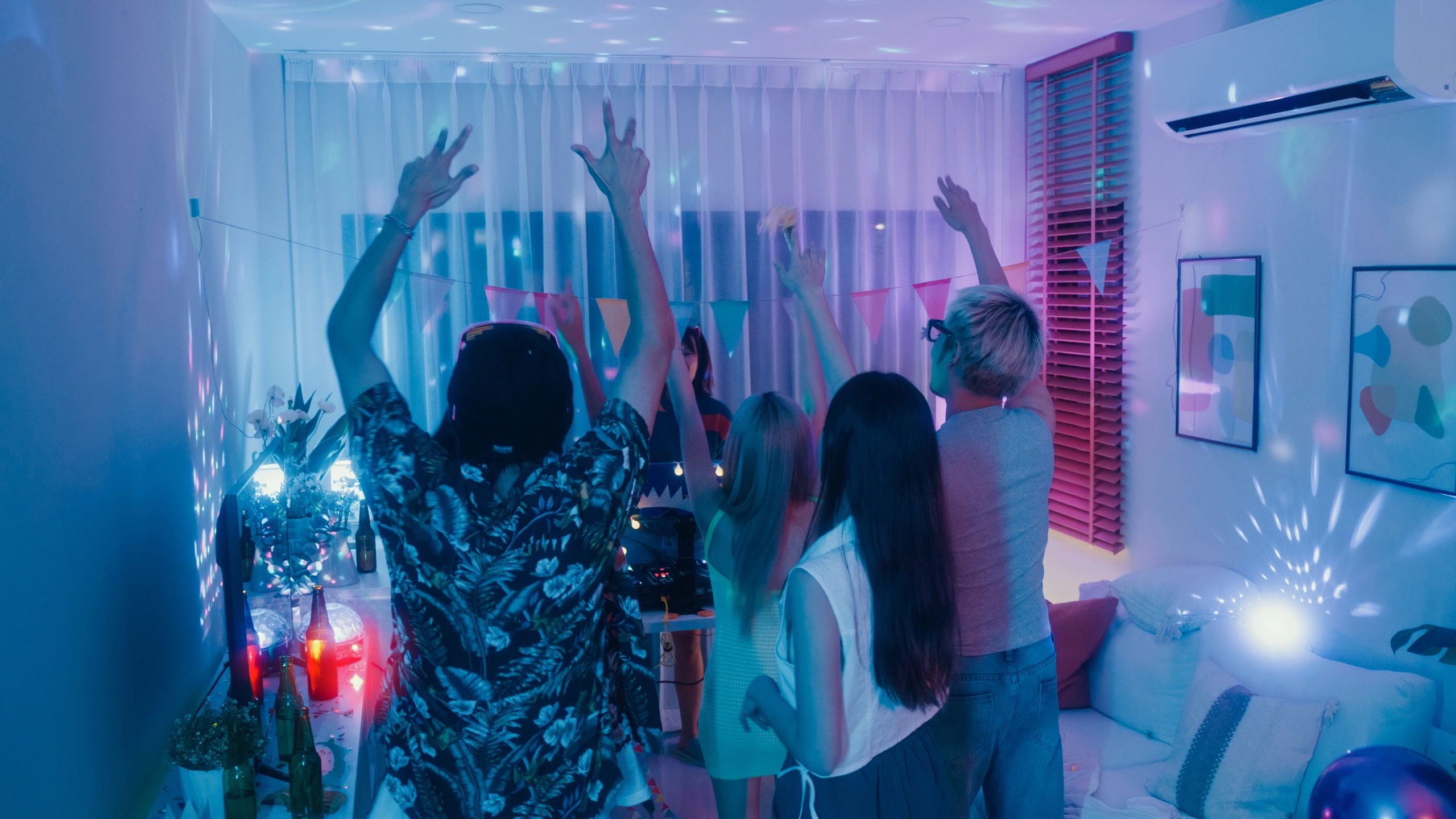 Packed dance floor with DJ and lights
